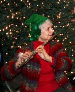 Gnome Flutist Cindy Butler, along with her students, fill the lobby with holiday tunes.